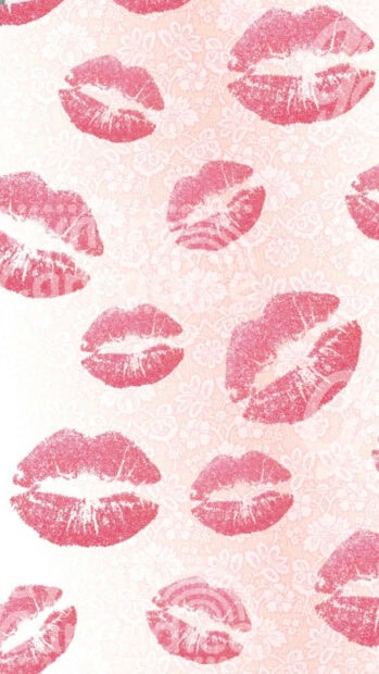 Pink lip prints scattered on a floral patterned background with lipstick marks