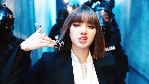 Lisa Blackpink wearing a black suit with unique rings and striking makeup in a dynamic pose
