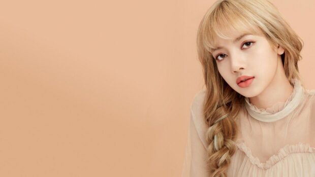Lisa Blackpink with long braided hair posing against a plain beige background
