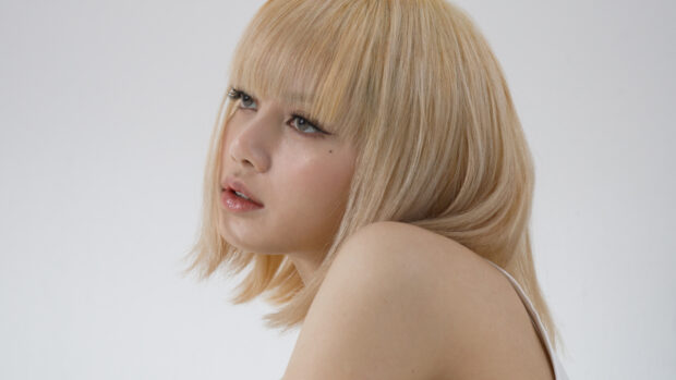 Lisa Blackpink with blonde hair looking thoughtful in a close up portrait