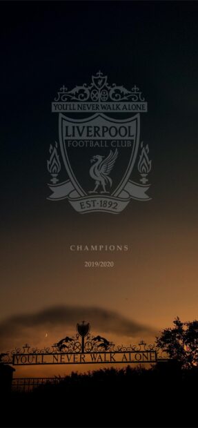 Liverpool football club emblem with the Youll Never Walk Alone gate at sunset