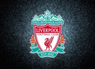 Liverpool Fc crest with the iconic Liver bird and club motto on a dark textured background
