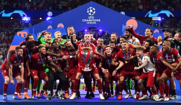 Liverpool Fc celebrating victory with UEFA Champions League trophy on field