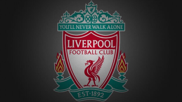 Liverpool football club crest with the motto you'll never walk alone on a dark background
