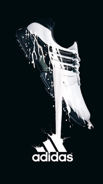 White Adidas shoe with paint splashes on black background showing logo Adidas