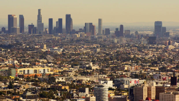 A panoramic view of Los Angeles skyline with tall buildings and urban landscape at sunset