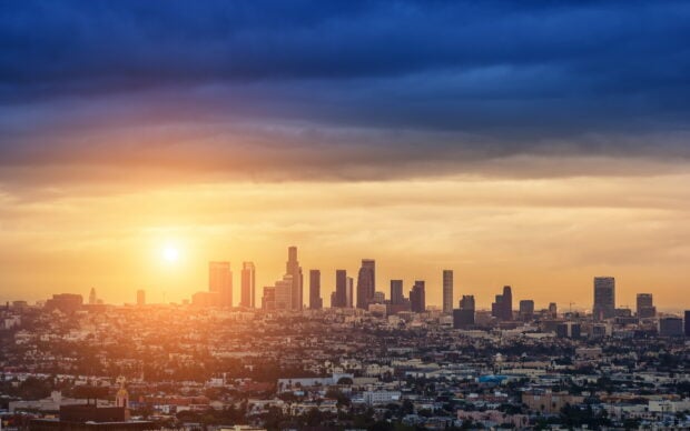 Los Angeles cityscape at sunset with clear sky and tall buildings in view
