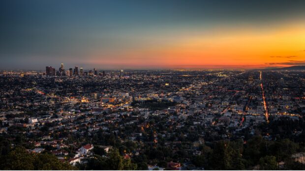 Los Angeles skyline at sunset with city lights glowing and clear sky