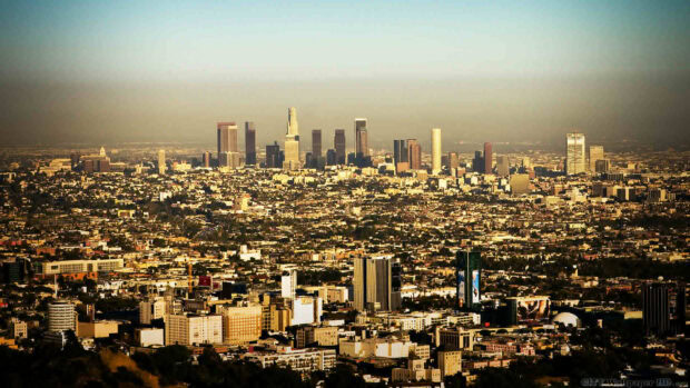A panoramic view of Los Angeles skyline at sunset showing urban landscape and tall buildings