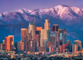 Los Angeles skyline with mountain range in the background during sunset
