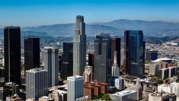 Los Angeles city skyline with tall buildings and mountains in the background