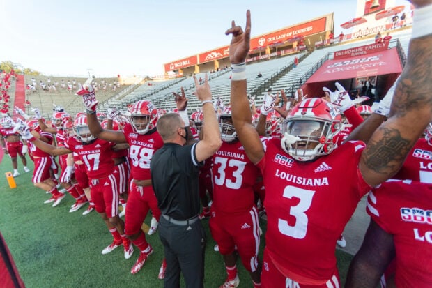 Louisiana football players celebrating on the field before the game in Louisiana