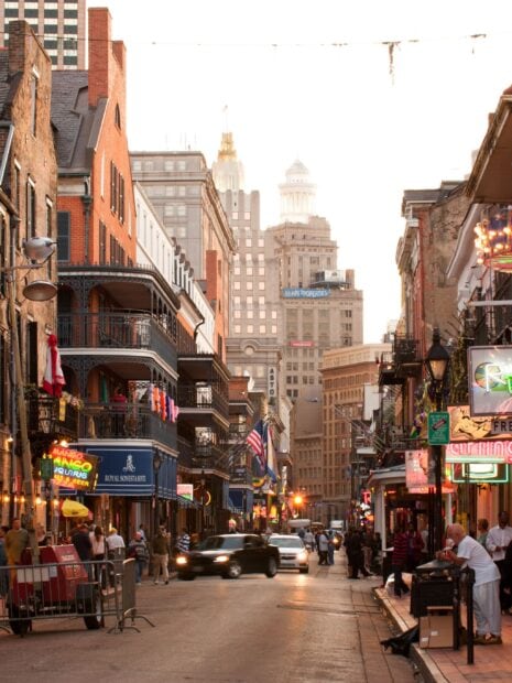 Busy street scene in Louisiana with historic buildings and colorful signs
