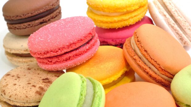 A close up of colorful macaron desserts in various flavors and textures