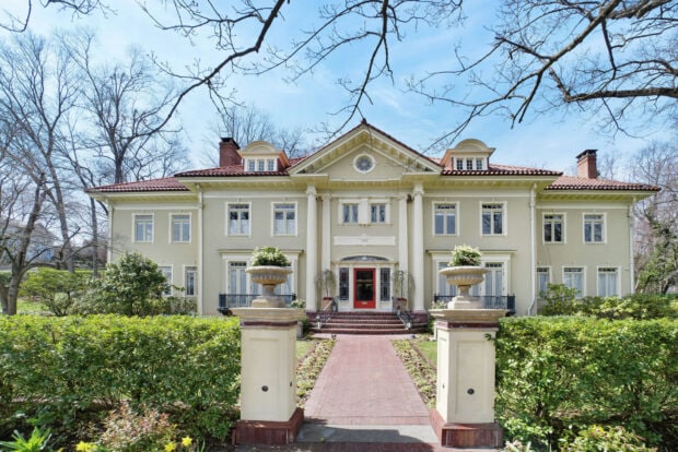 Elegant mansion with classic architecture and lush garden in spring season