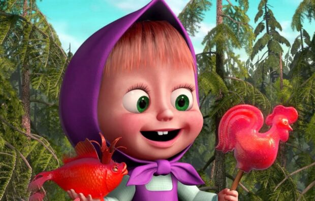 Masha holding a red fish and a rooster shaped candy in the forest background