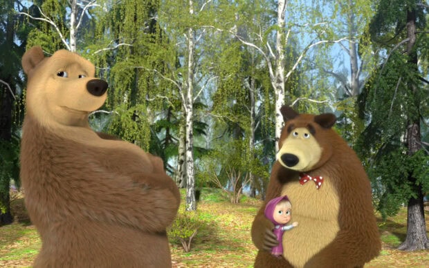 The bear holding a small girl character in the forest from Masha and the Bear