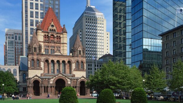 Historic Massachusetts architecture with modern city buildings and green park area in Boston