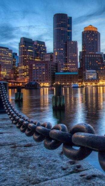 Chain links at the waterfront with Massachusetts city skyline in the background