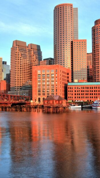 Historic buildings of Massachusetts reflected on the water at sunset