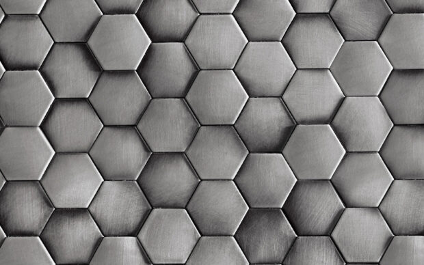 Close up of metal hexagon texture with brushed steel surface pattern