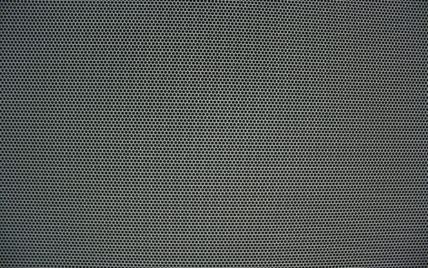 Close up of metal mesh texture with hexagonal pattern and gray color