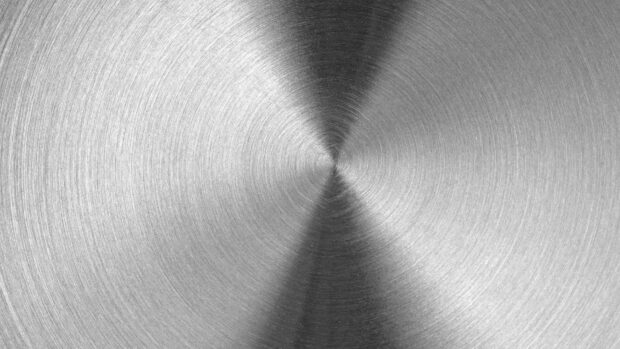 Circular brushed metal texture with detailed grooves and radial pattern