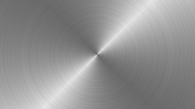 Circular brushed metal texture with concentric patterns creating a shiny metallic surface