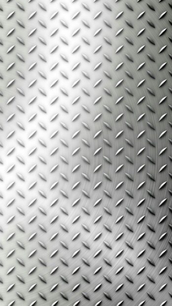 Close up of a metal texture with raised patterns on a shiny surface
