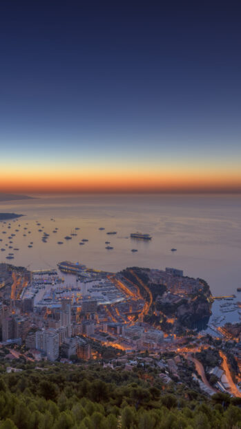Aerial view of Monaco harbor and cityscape during sunset showcasing Monaco scenery