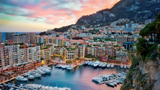 A beautiful Monaco cityscape with colorful buildings and yachts in the marina at sunset