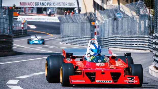A vintage Formula race car speeding on a Monaco Grand Prix street circuit during a motorsports event