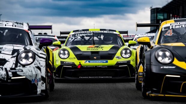 Green and black Porsche race car with number 92 on the track during motorsports event