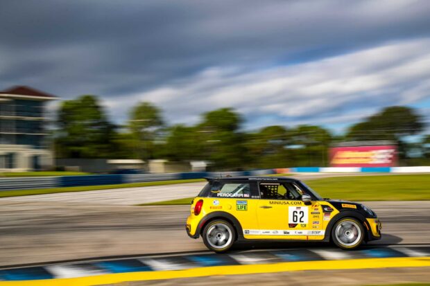 Racing car with number 62 speeding on the race track during a motorsports event