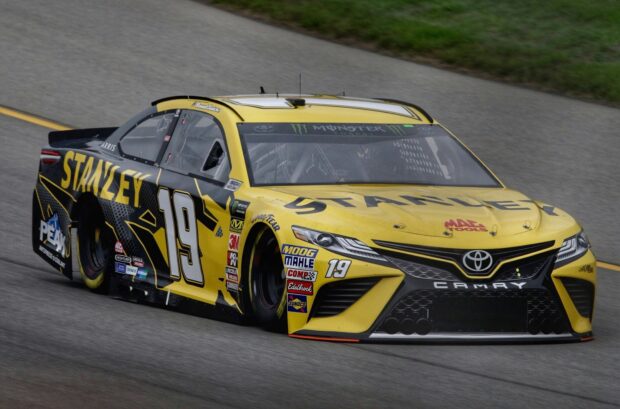 Yellow Stanley racing car number 19 speeding on the race track in motorsports