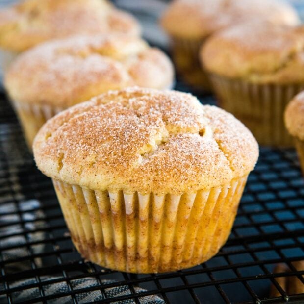 A freshly baked muffin with a cinnamon sugar topping on a cooling rack