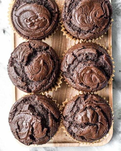 Close up of chocolate muffin baked with rich cocoa in a paper cup viewed from above