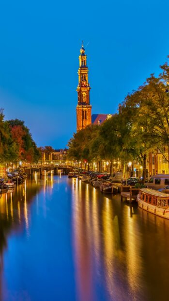 Evening view of canal and church tower in Netherlands cityscape