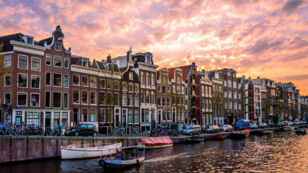 Traditional buildings along a canal in Netherlands at sunset with clear sky