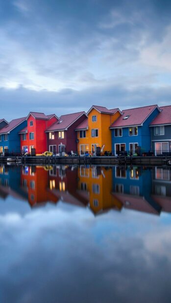 Colorful homes along the waterfront in Netherlands reflecting on the calm water