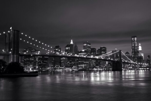 New York city skyline with the Brooklyn bridge in black and white at night