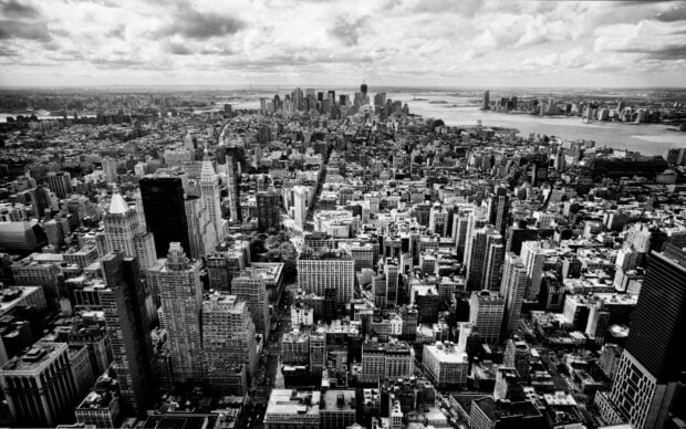Aerial view of New York cityscape in black and white showing urban architecture