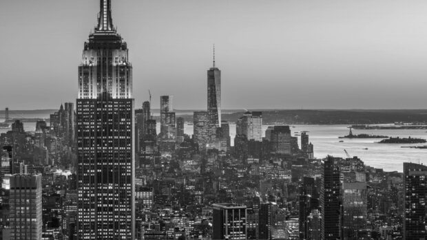 New York city skyline in black and white with iconic skyscrapers and waterfront at dusk