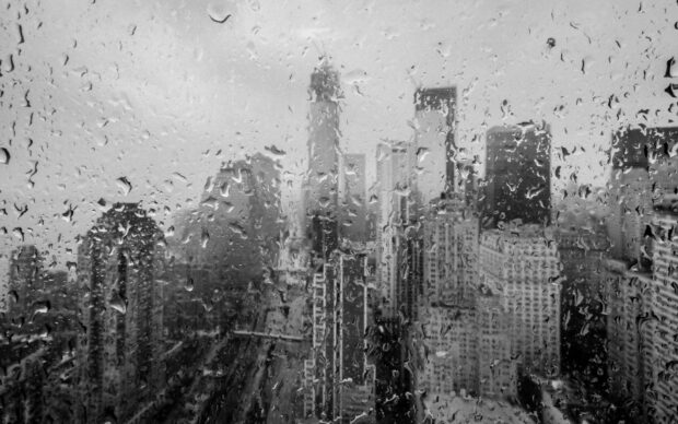 New York cityscape seen through a rain covered window with a moody black and white atmosphere