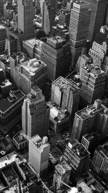 Black and white cityscape of New York showcasing tall buildings and busy streets in detail