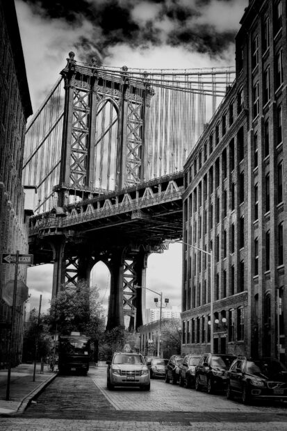 Manhattan bridge and urban streetscape in New York city black and white