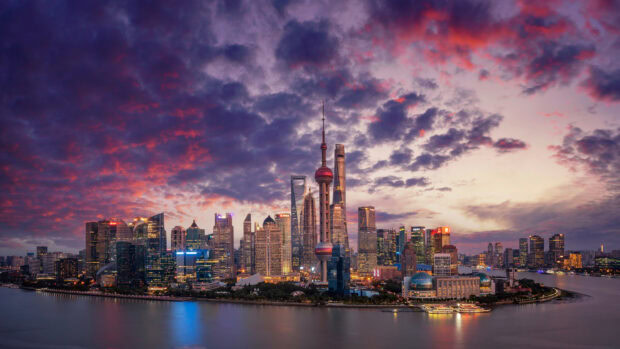 Shanghai city skyline with colorful clouds at night displaying urban architecture