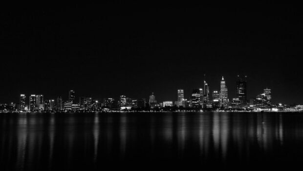 Night skyline at night with illuminated buildings reflecting on the water