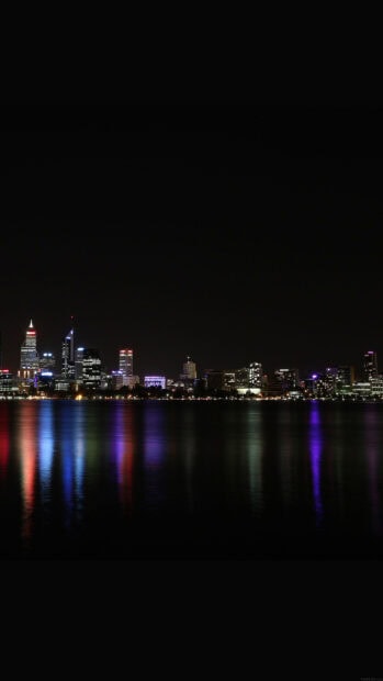 Night skyline with colorful lights reflecting on water at night
