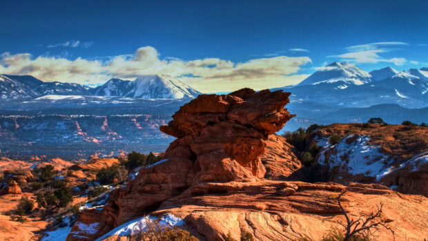 Red rock formations and snow covered mountains in North America landscape